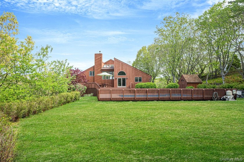 Set within the quiet Rolling Woods neighborhood on a shy acre at - photo 15