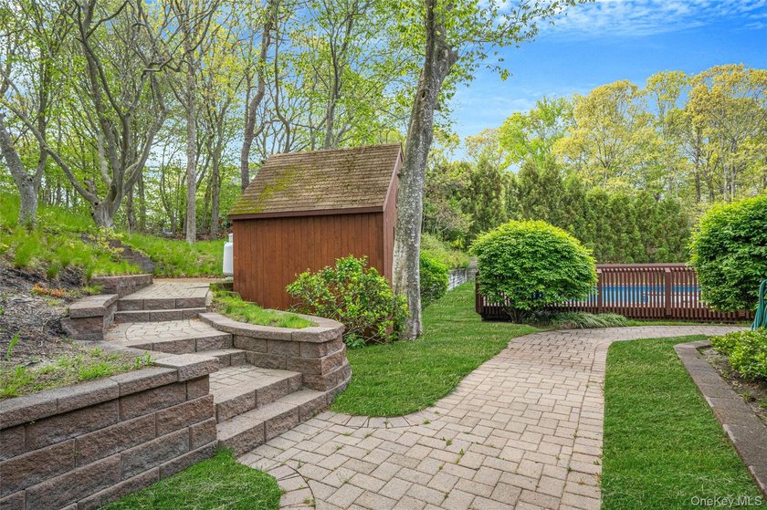 Set within the quiet Rolling Woods neighborhood on a shy acre at - photo 16