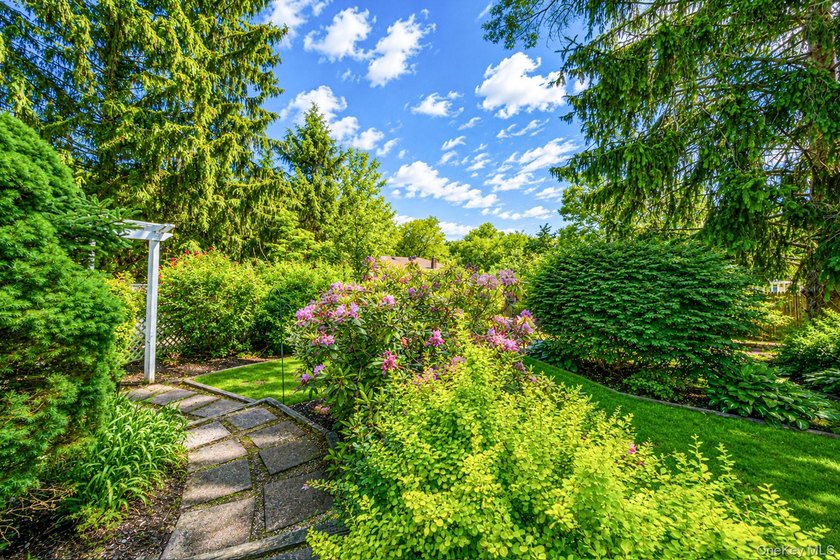 Nestled on a beautifully landscaped property surrounded by - photo 36