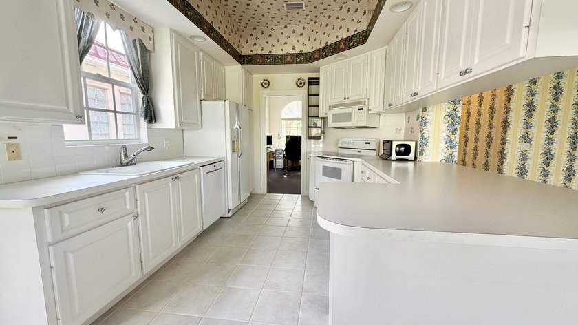This well-designed home features 12-foot ceilings in the great - photo 6