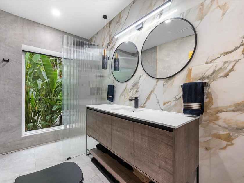 LUXURY updated 4 bedroom/3 bathroom SMART home in Coral Ridge - photo 22