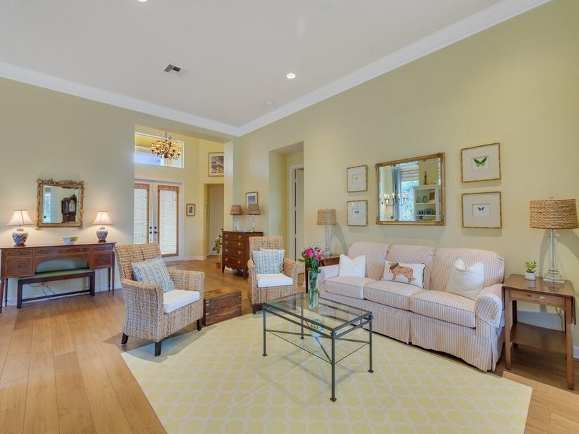This pool home features a 2022 roof, laminate flooring - photo 4