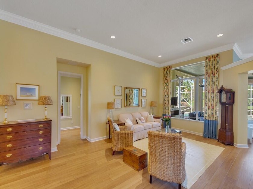 This pool home features a 2022 roof, laminate flooring - photo 5