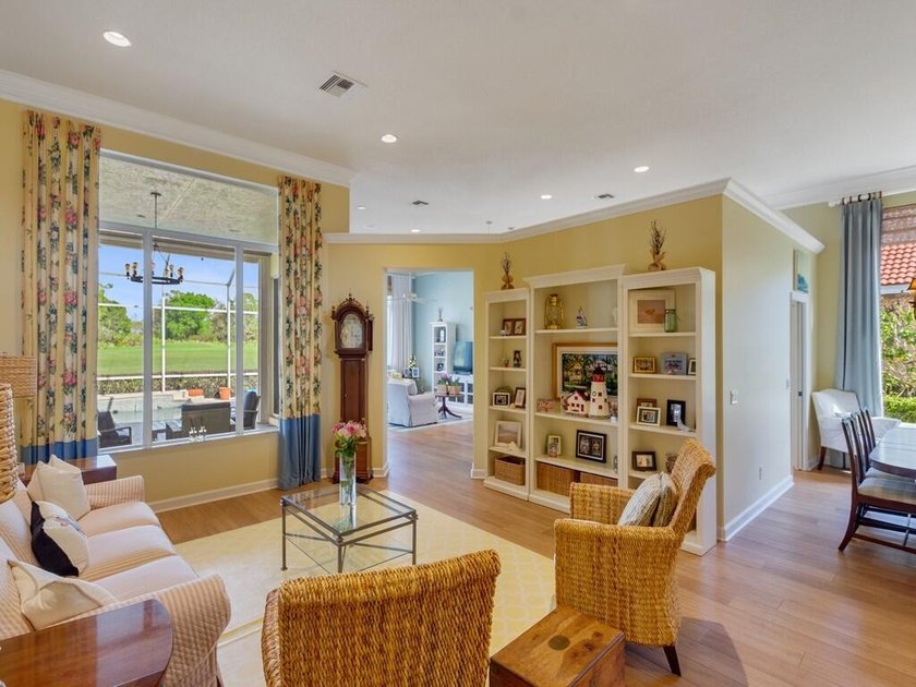 This pool home features a 2022 roof, laminate flooring - photo 7