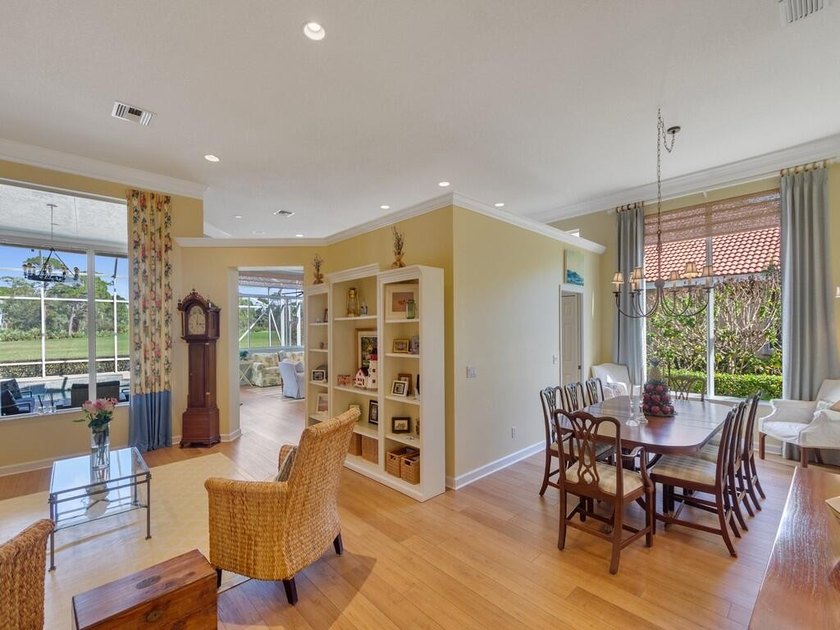 This pool home features a 2022 roof, laminate flooring - photo 8