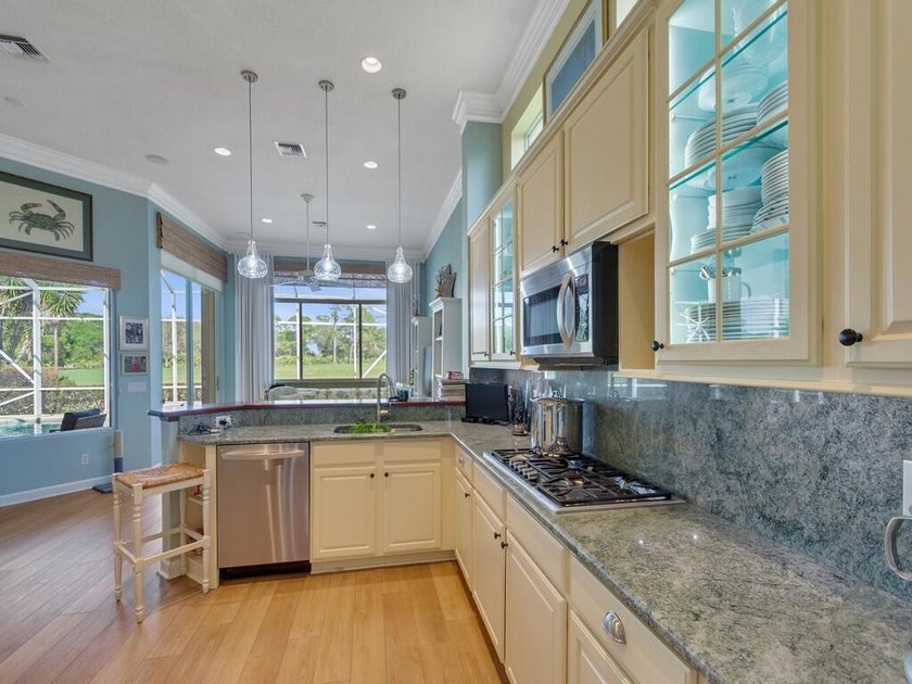 This pool home features a 2022 roof, laminate flooring - photo 10