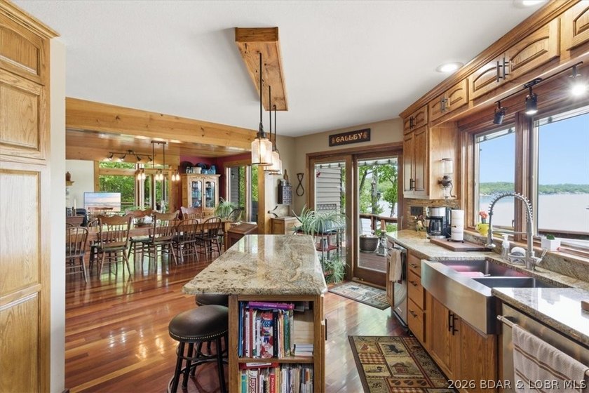 Vaulted ceilings, walls of windows, and wood-burning fireplace - photo 12