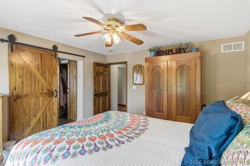 Vaulted ceilings, walls of windows, and wood-burning fireplace - photo 19
