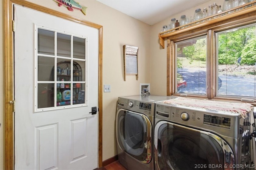 Vaulted ceilings, walls of windows, and wood-burning fireplace - photo 23