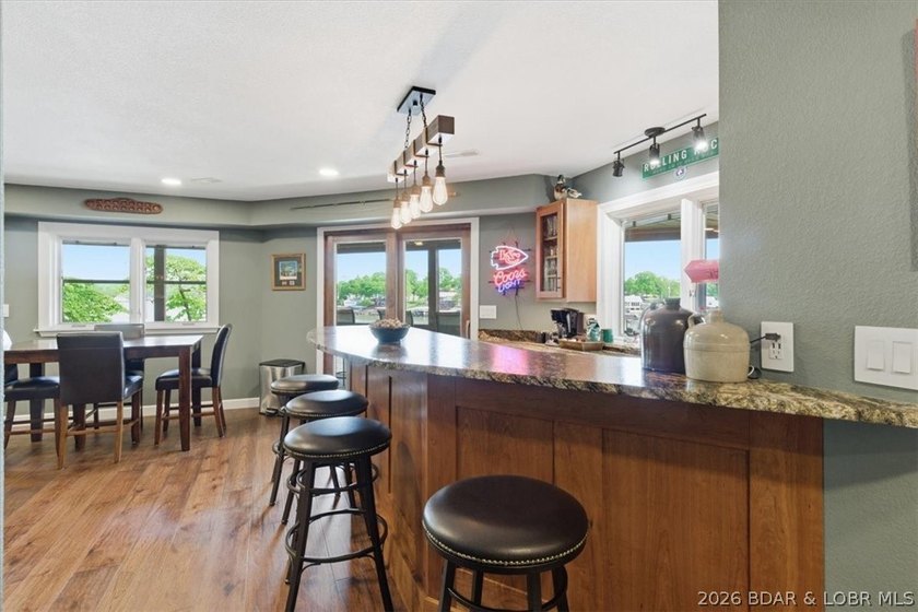 Vaulted ceilings, walls of windows, and wood-burning fireplace - photo 25