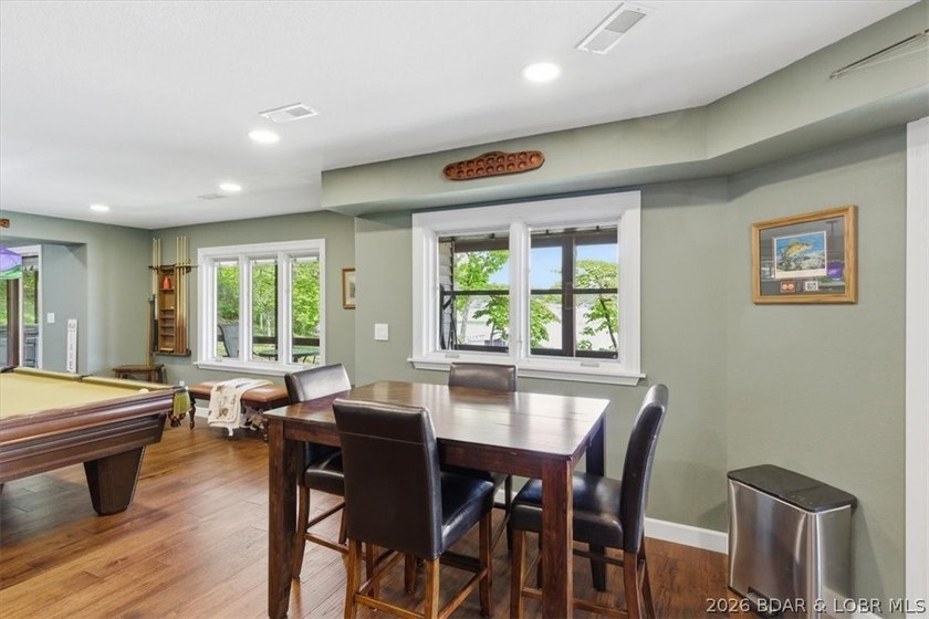 Vaulted ceilings, walls of windows, and wood-burning fireplace - photo 28