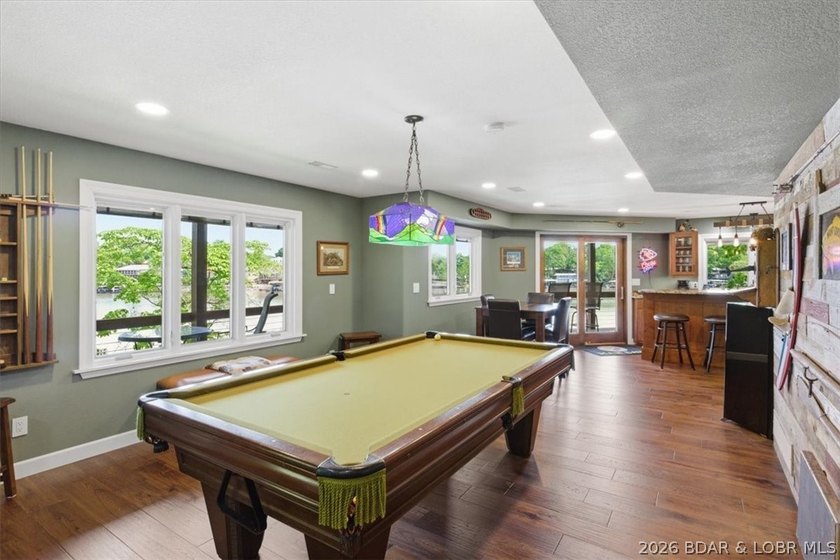 Vaulted ceilings, walls of windows, and wood-burning fireplace - photo 29
