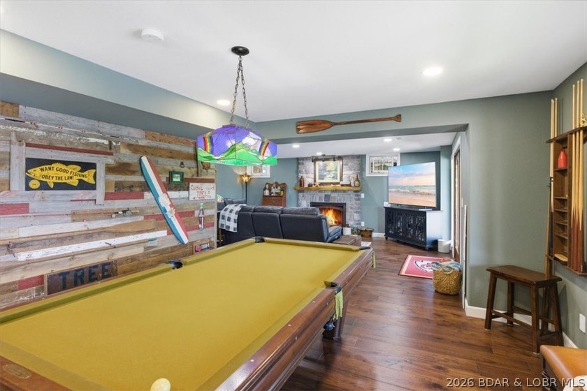 Vaulted ceilings, walls of windows, and wood-burning fireplace - photo 30