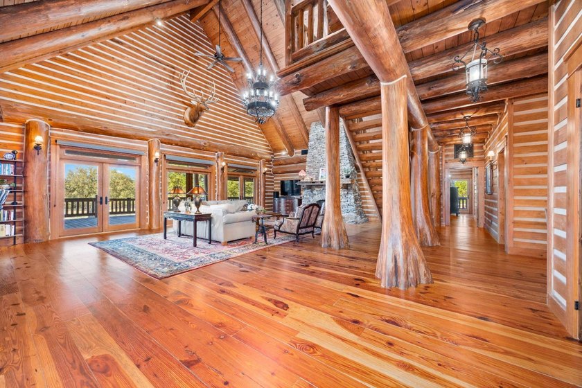 This riverfront property features an expansive, custom log home - photo 3