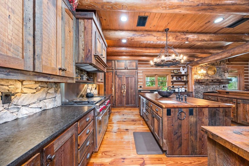 This riverfront property features an expansive, custom log home - photo 9