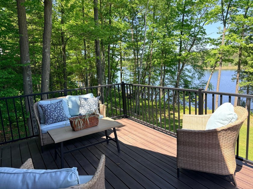Set on a beautifully wooded 1.7-acre lot with 393 feet of sandy - photo 13