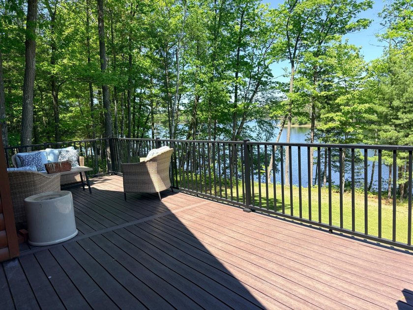 Set on a beautifully wooded 1.7-acre lot with 393 feet of sandy - photo 14