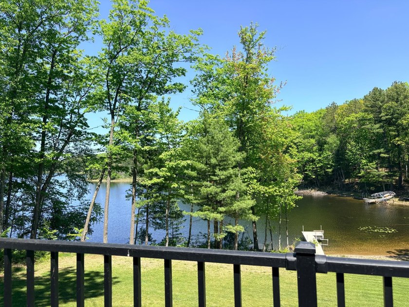 Set on a beautifully wooded 1.7-acre lot with 393 feet of sandy - photo 15