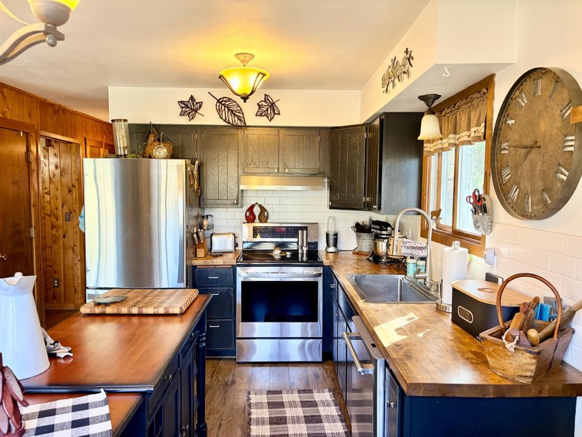 Set on a beautifully wooded 1.7-acre lot with 393 feet of sandy - photo 16
