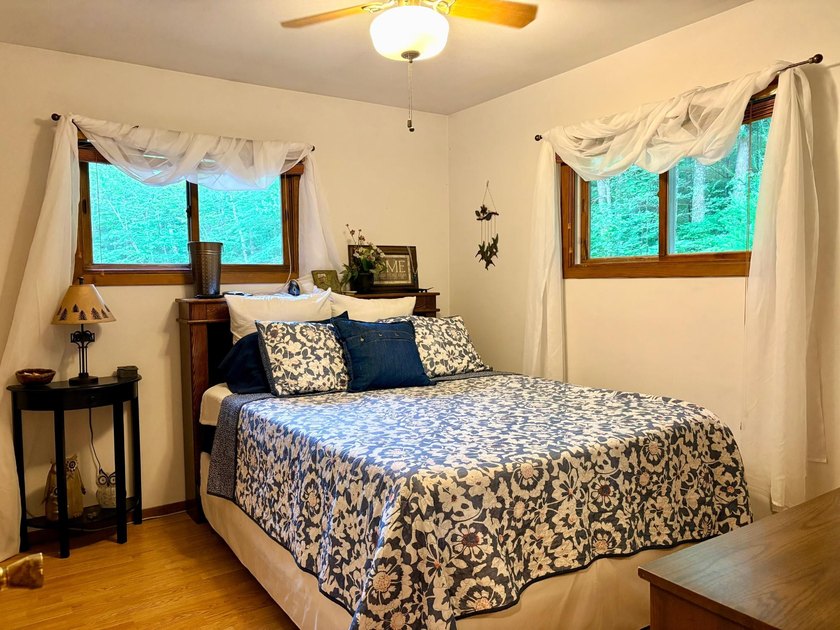 Set on a beautifully wooded 1.7-acre lot with 393 feet of sandy - photo 21
