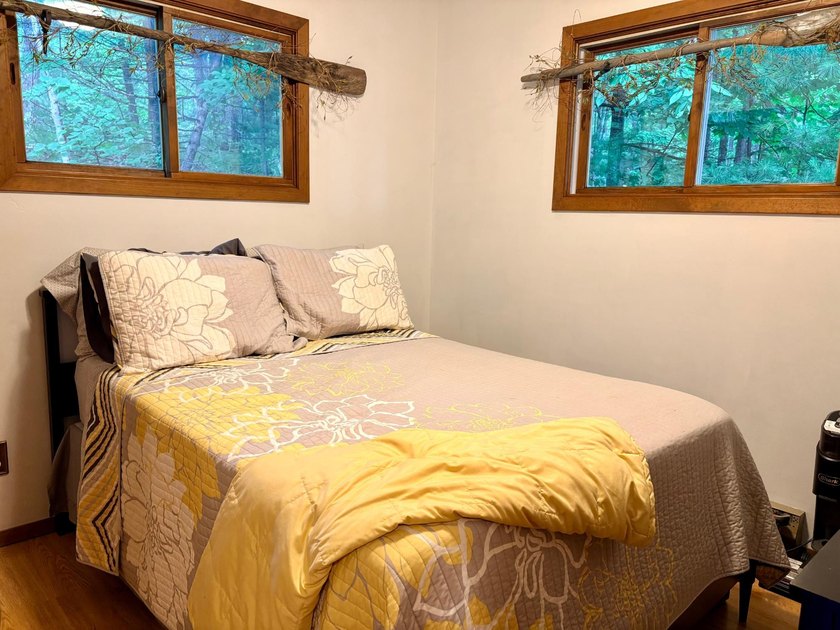 Set on a beautifully wooded 1.7-acre lot with 393 feet of sandy - photo 23