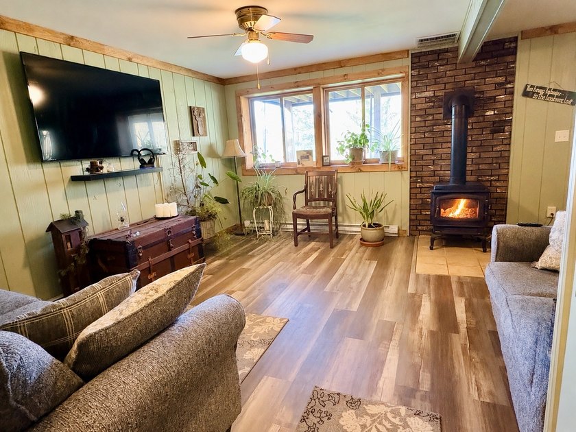 Set on a beautifully wooded 1.7-acre lot with 393 feet of sandy - photo 25