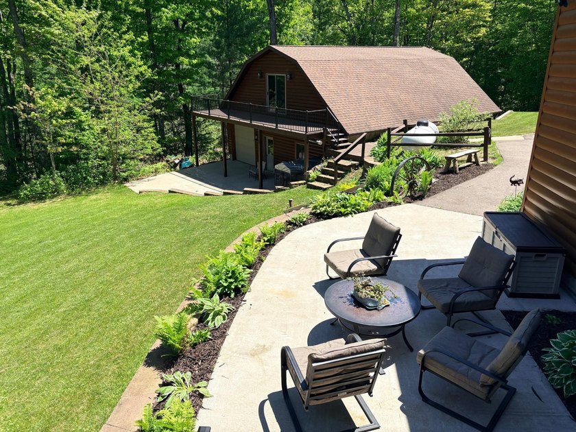 Set on a beautifully wooded 1.7-acre lot with 393 feet of sandy - photo 31