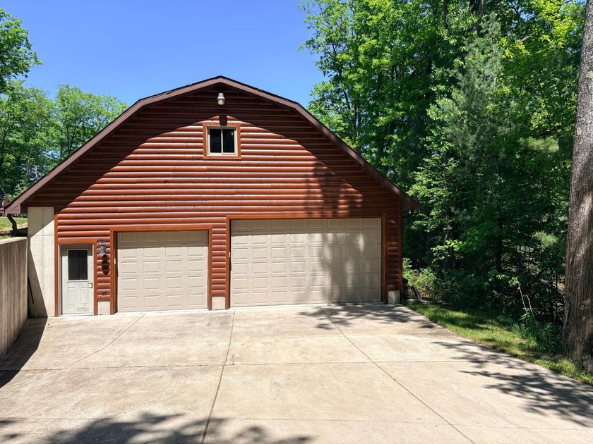 Set on a beautifully wooded 1.7-acre lot with 393 feet of sandy - photo 35