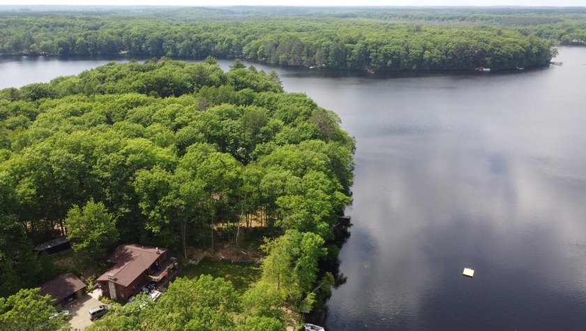 Set on a beautifully wooded 1.7-acre lot with 393 feet of sandy - photo 39