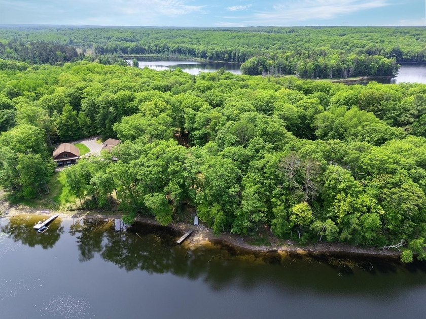 Set on a beautifully wooded 1.7-acre lot with 393 feet of sandy - photo 40