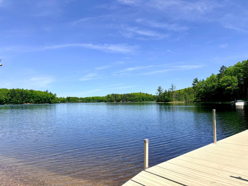 Set on a beautifully wooded 1.7-acre lot with 393 feet of sandy - photo 41