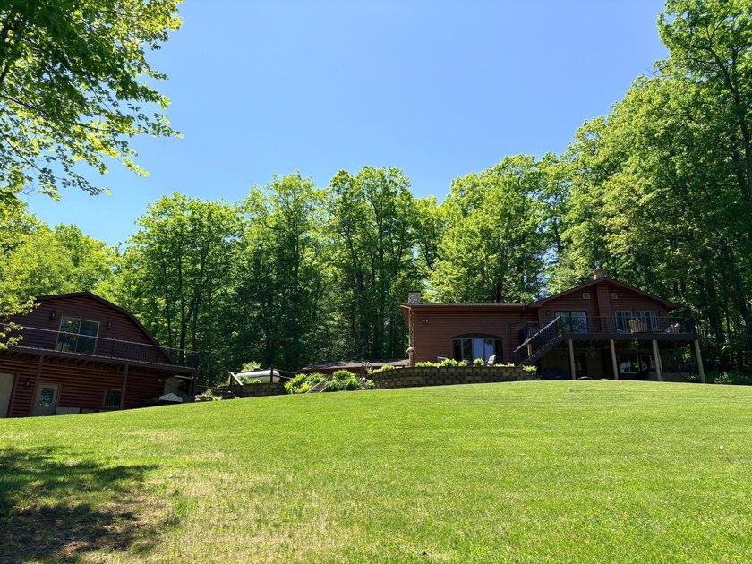 Set on a beautifully wooded 1.7-acre lot with 393 feet of sandy - photo 42