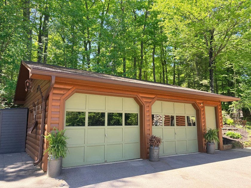 Set on a beautifully wooded 1.7-acre lot with 393 feet of sandy - photo 43