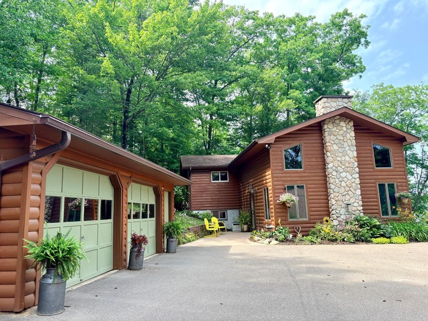 Set on a beautifully wooded 1.7-acre lot with 393 feet of sandy - photo 44
