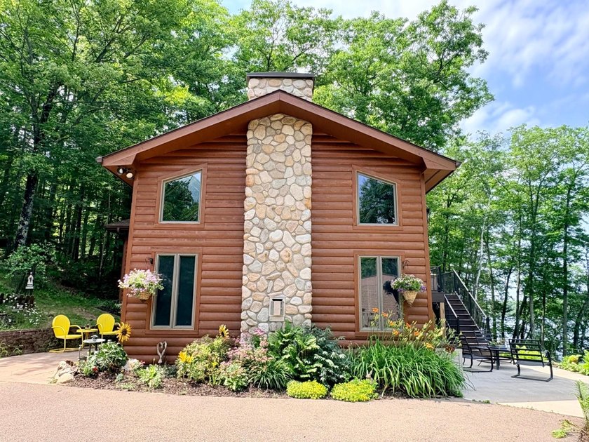 Set on a beautifully wooded 1.7-acre lot with 393 feet of sandy - photo 45
