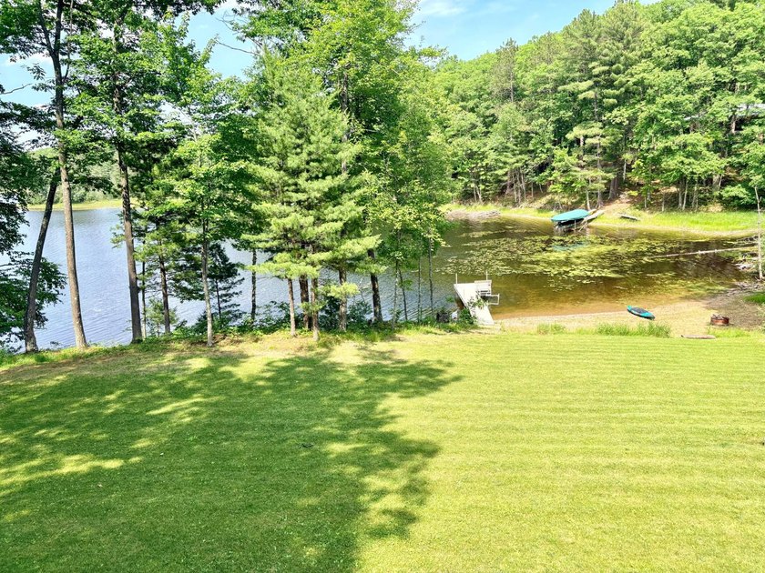 Set on a beautifully wooded 1.7-acre lot with 393 feet of sandy - photo 48