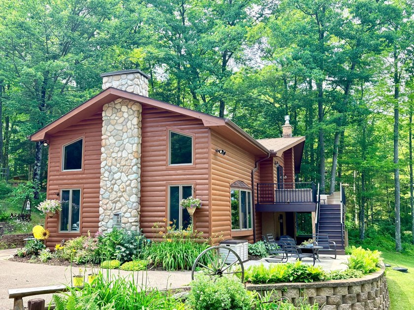 Set on a beautifully wooded 1.7-acre lot with 393 feet of sandy - photo 49