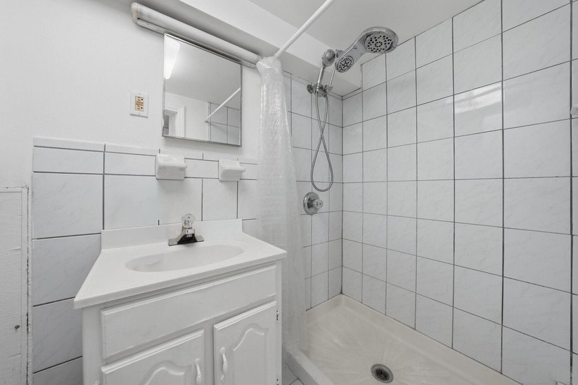 Move right into this lovely renovated two-family townhouse - photo 8