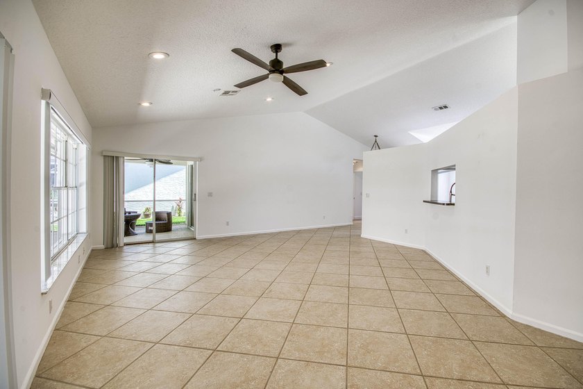 Manicured landscaping and soaring vaulted ceilings welcome you - photo 19