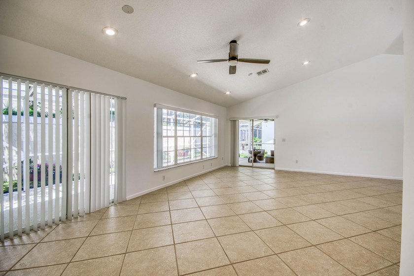Manicured landscaping and soaring vaulted ceilings welcome you - photo 20