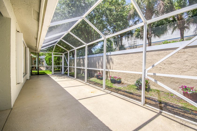 Manicured landscaping and soaring vaulted ceilings welcome you - photo 24