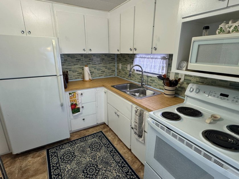 This 1971 home is offered turnkey and includes the golf cart! - photo 9