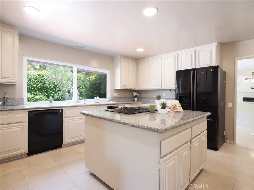 Situated on a quiet street overlooking a lush greenbelt in the - photo 12