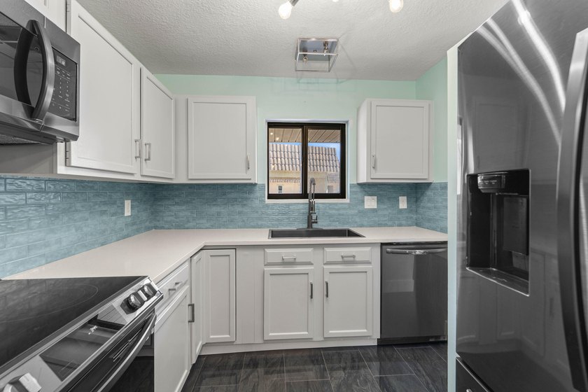 Newly remodeled 2/2 waterfront North Palm condo available on the - photo 16