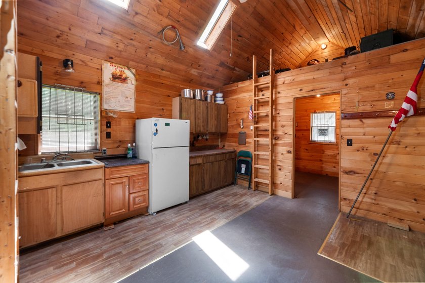Tucked away on a private lot, this charming camp offers the - photo 3