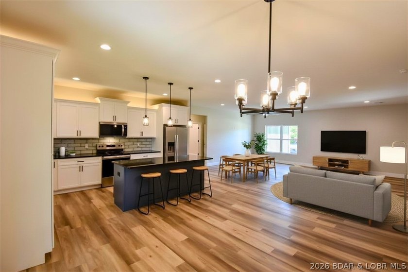 BRAND NEW HOME in the HEART of Osage Beach!! This striking home - photo 12