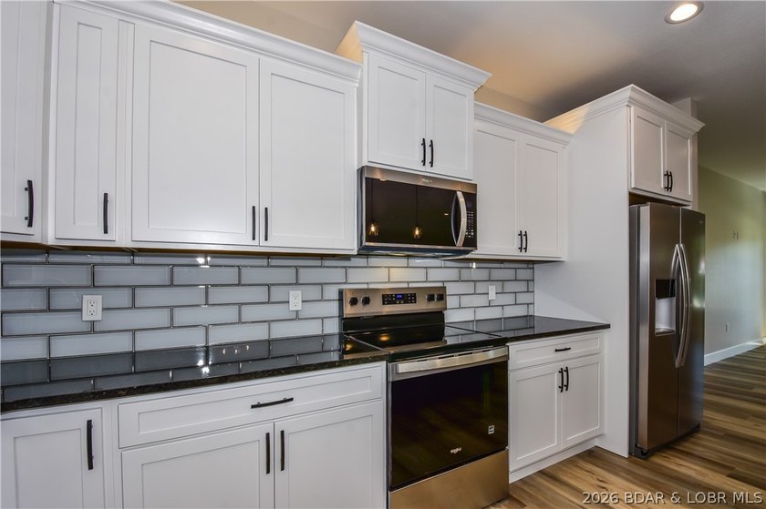 BRAND NEW HOME in the HEART of Osage Beach!! This striking home - photo 14