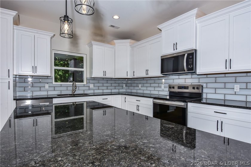 BRAND NEW HOME in the HEART of Osage Beach!! This striking home - photo 15