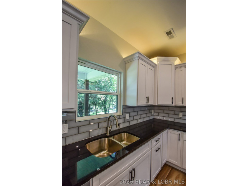 BRAND NEW HOME in the HEART of Osage Beach!! This striking home - photo 16