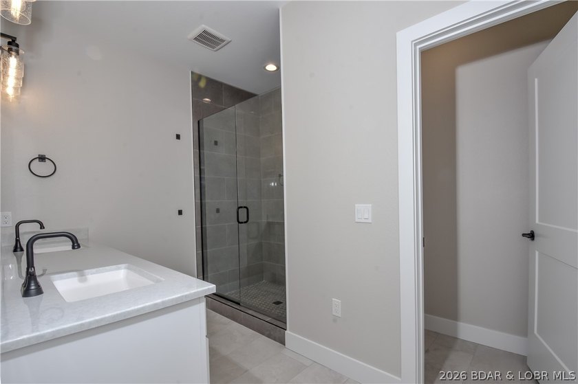 BRAND NEW HOME in the HEART of Osage Beach!! This striking home - photo 27